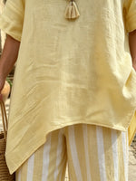Women's Yellow Asymmetrical Top and Striped Pants Set